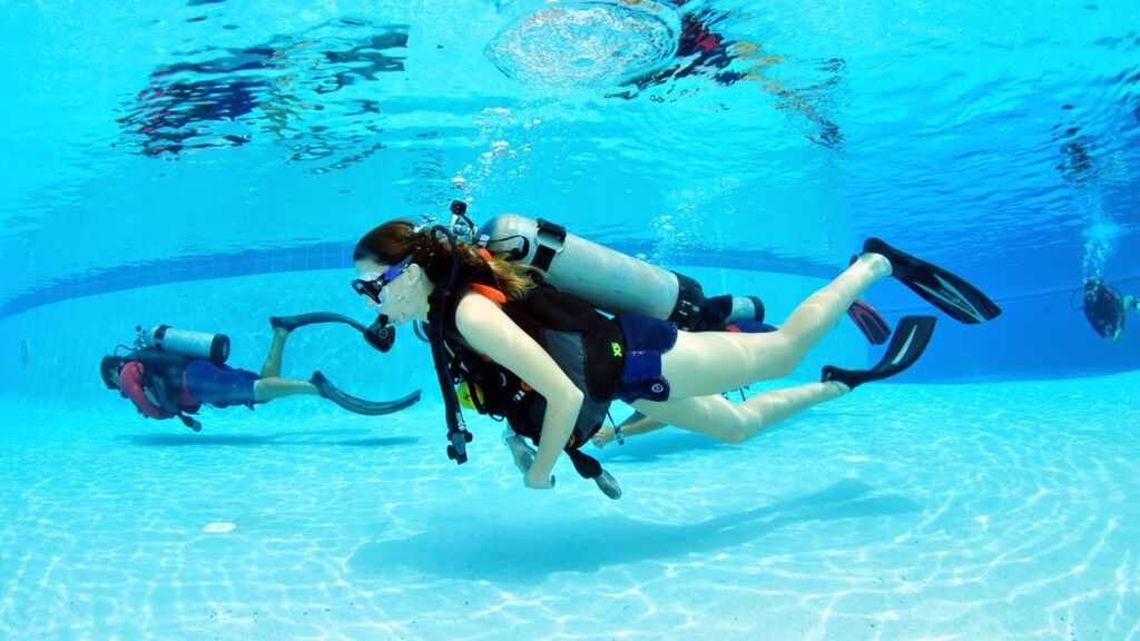Scuba diving beginners in pool