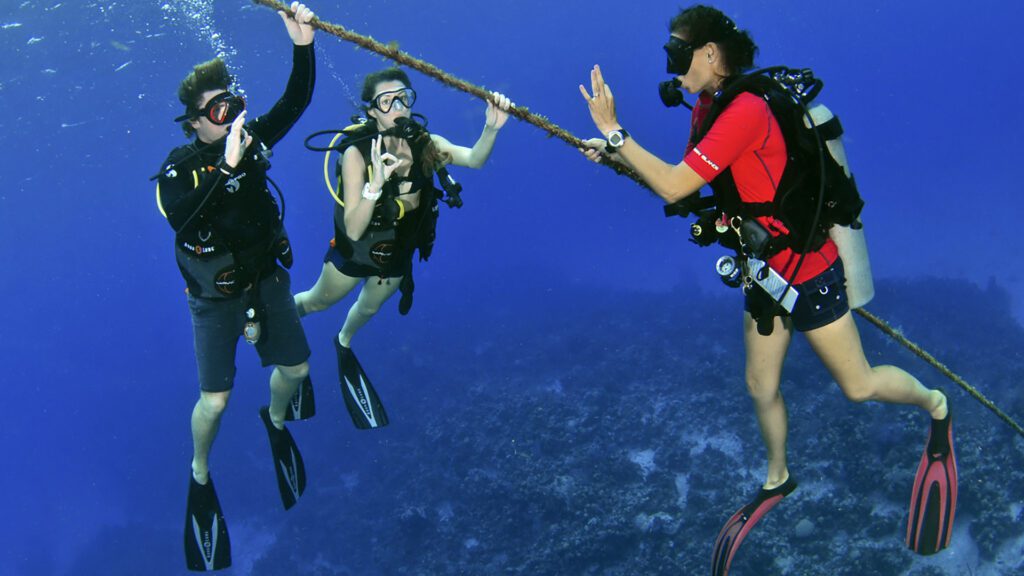 Scuba diving instructor with 2 divers