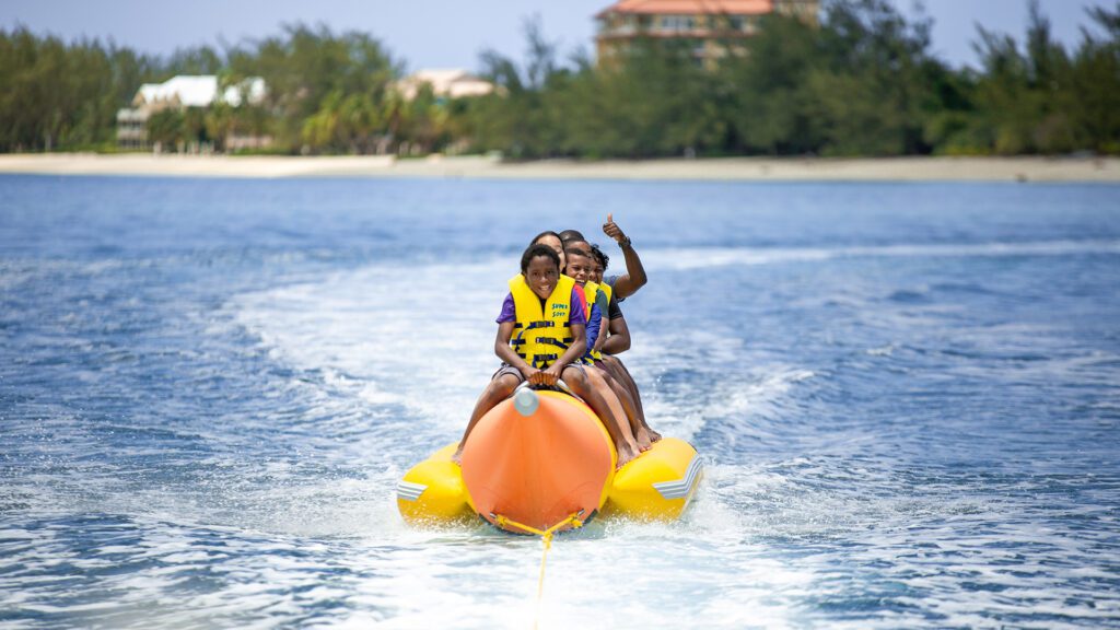 Group enjoying banana boat in Cayman Islands