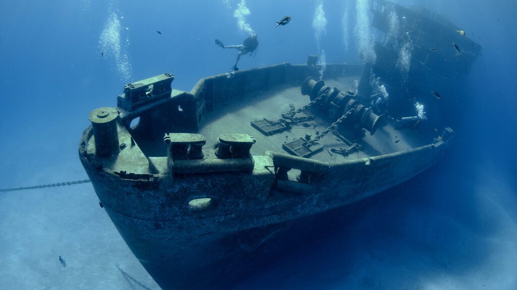 Divers at the kittiwake wreck in the Caribbean