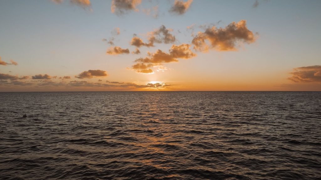 Sunsetting with clouds over the ocean